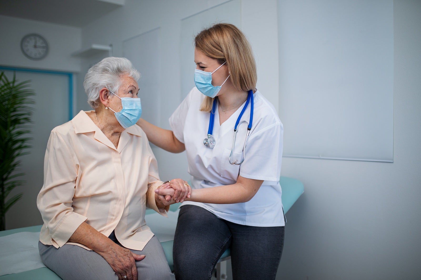 A nurse talking with a woman in a medical center