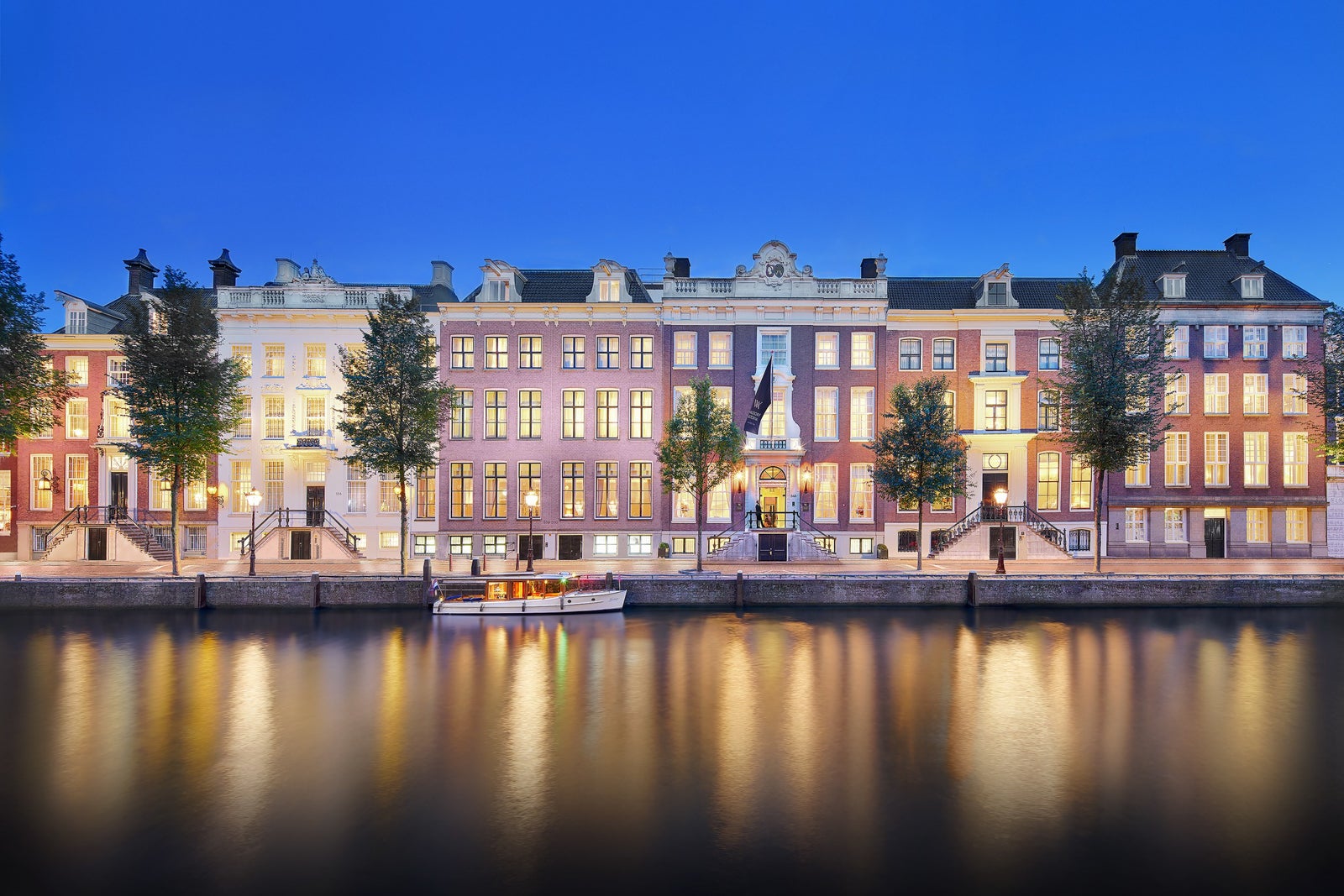 Waldorf Astoria Amsterdam and canal at twilight