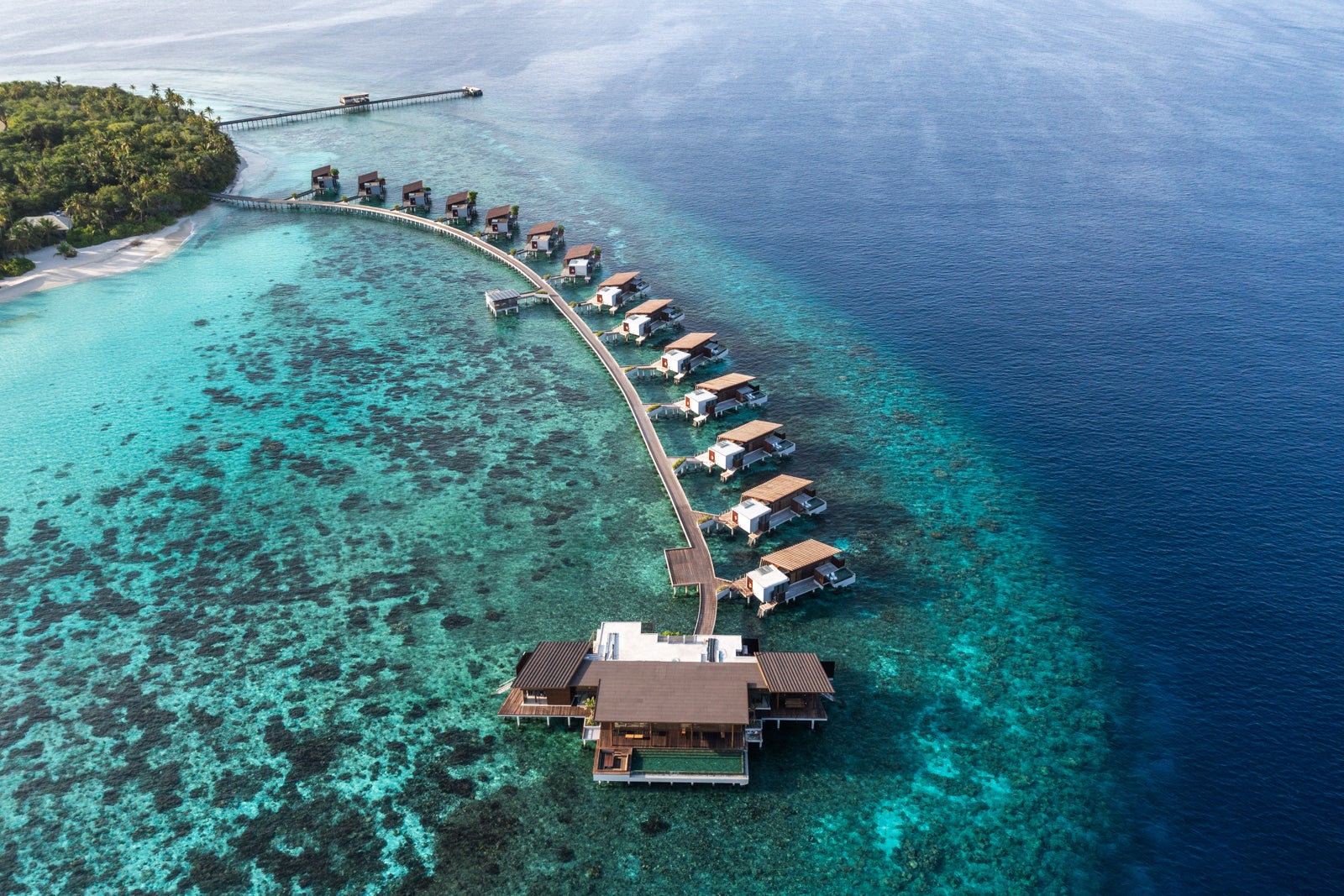 aerial view of Park Hyatt Maldives overwater bungalows in shallow ocean water