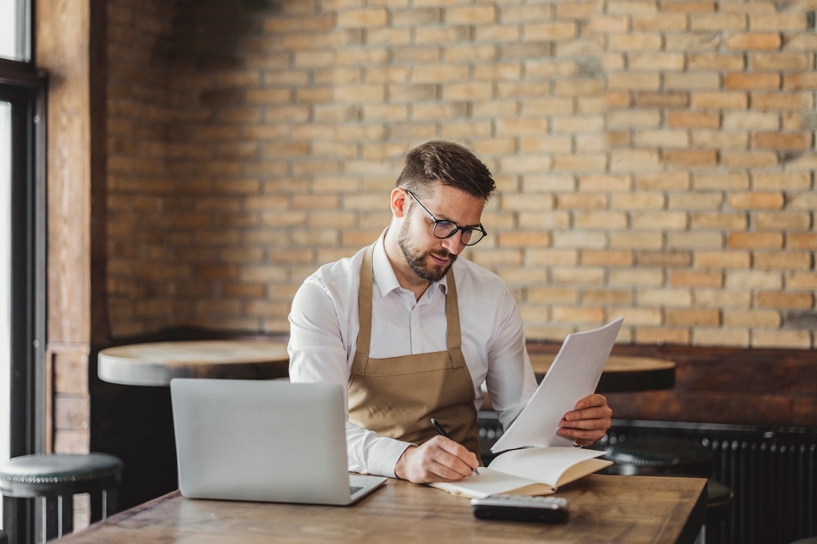 Coffee Shop Owner doing some Paperwork