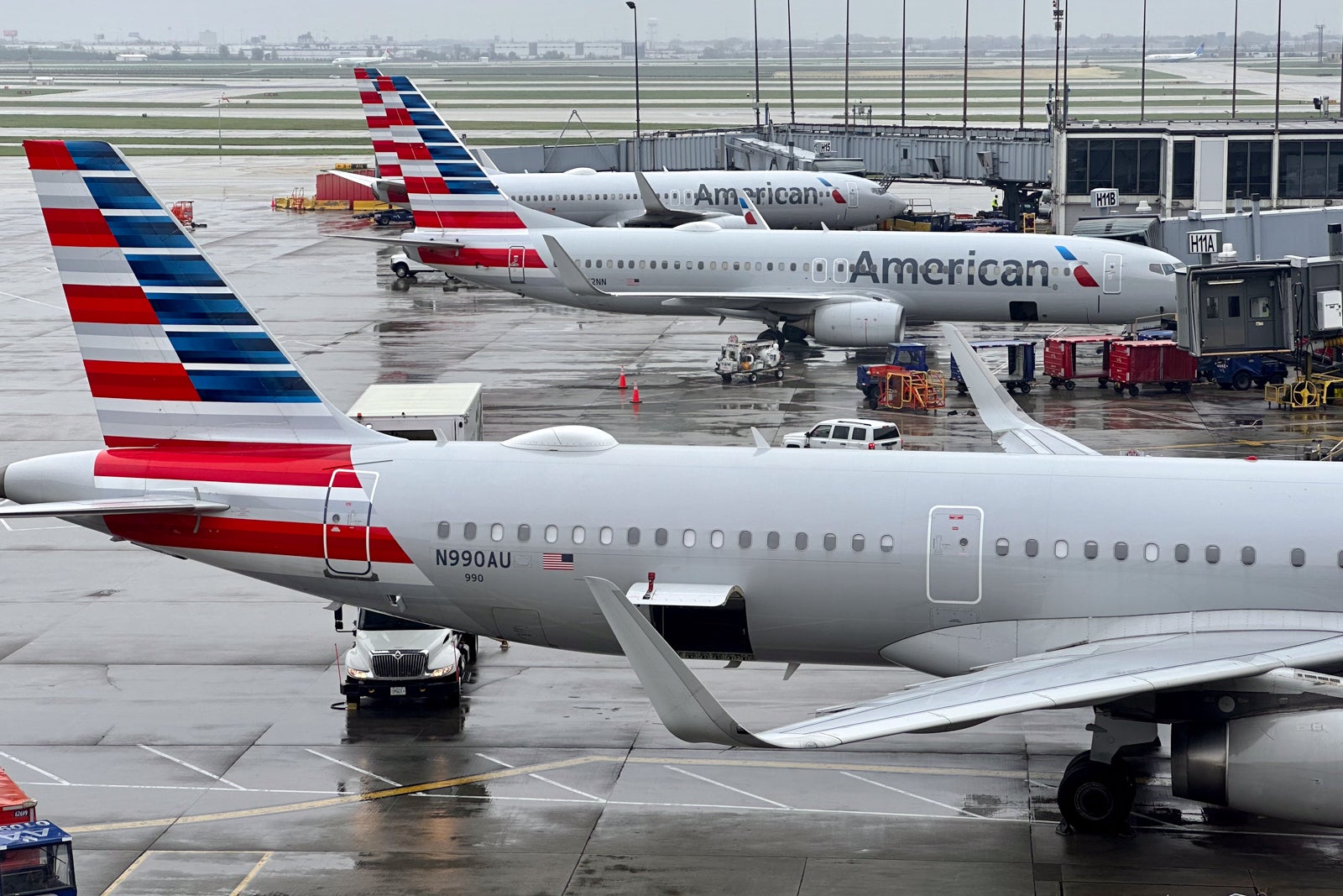 American planes lined up at airport gates