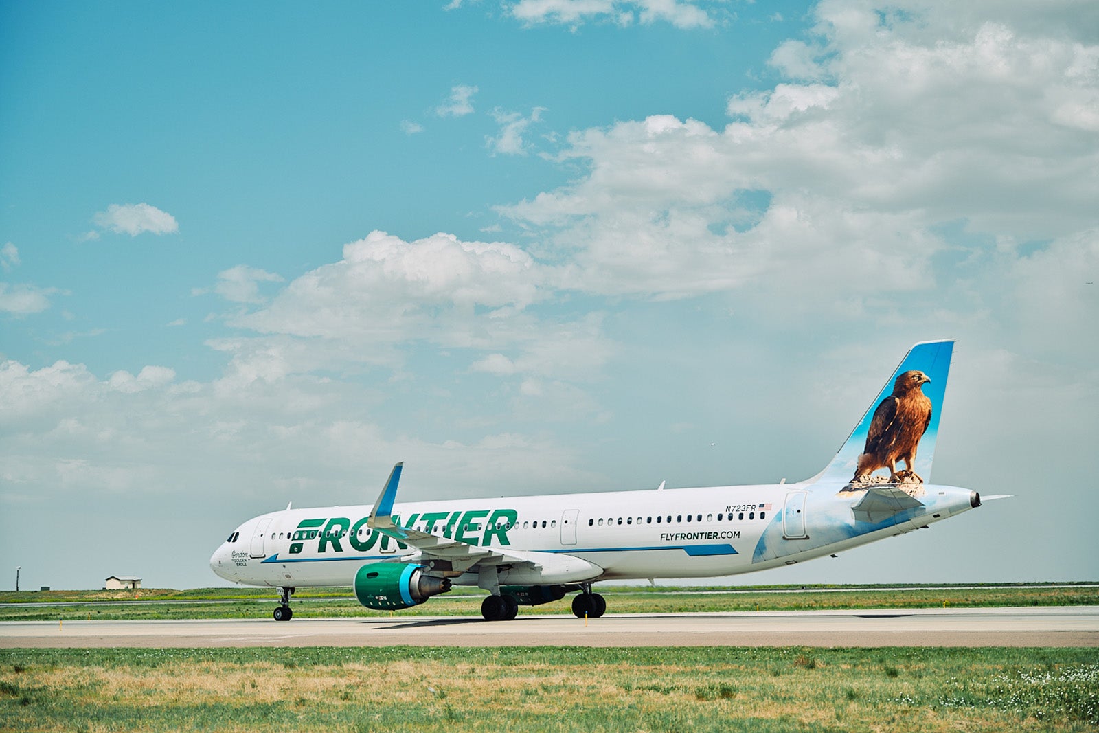 Frontier Airlines plane taxis at airport