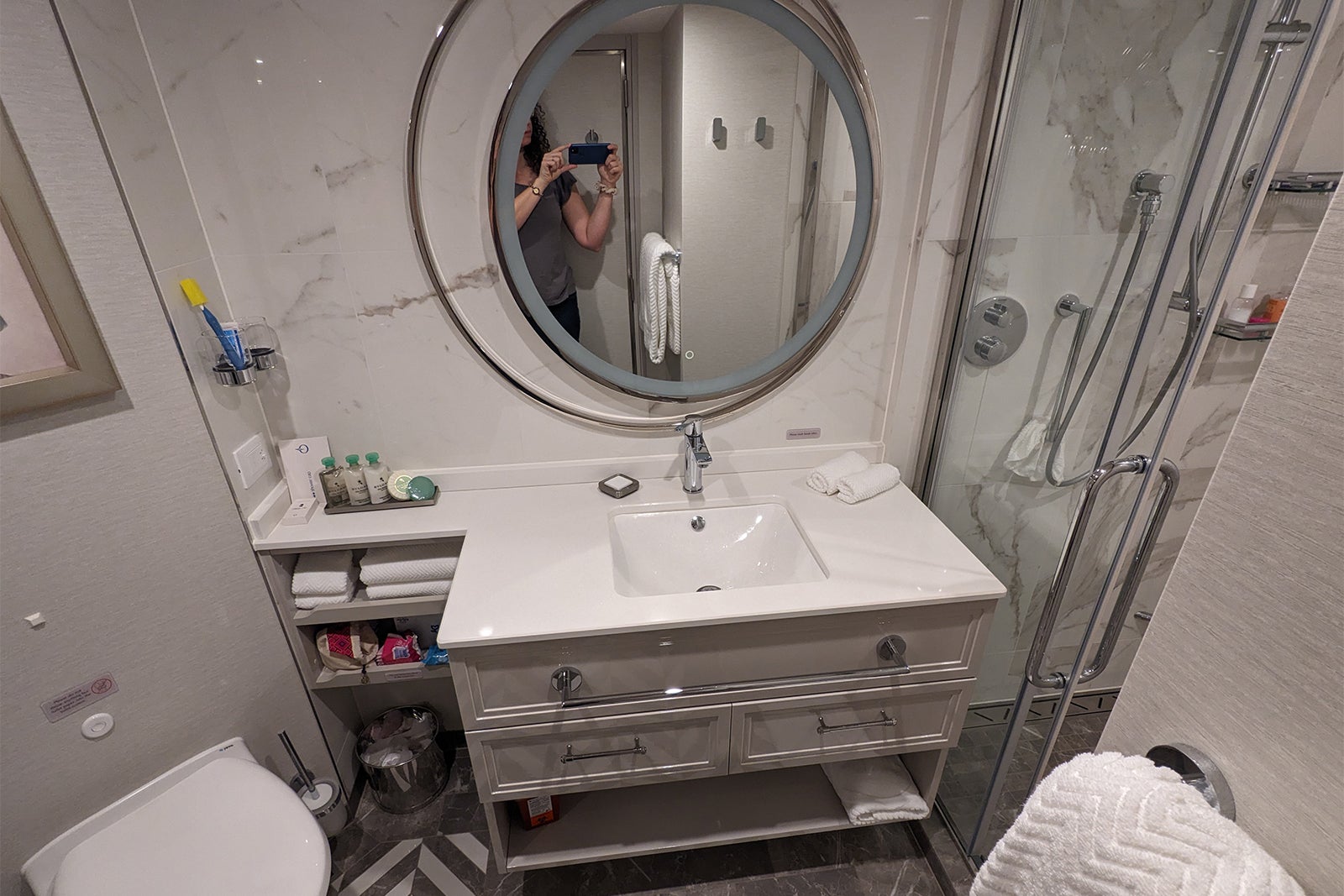 Round mirror and vanity in cruise ship bathroom