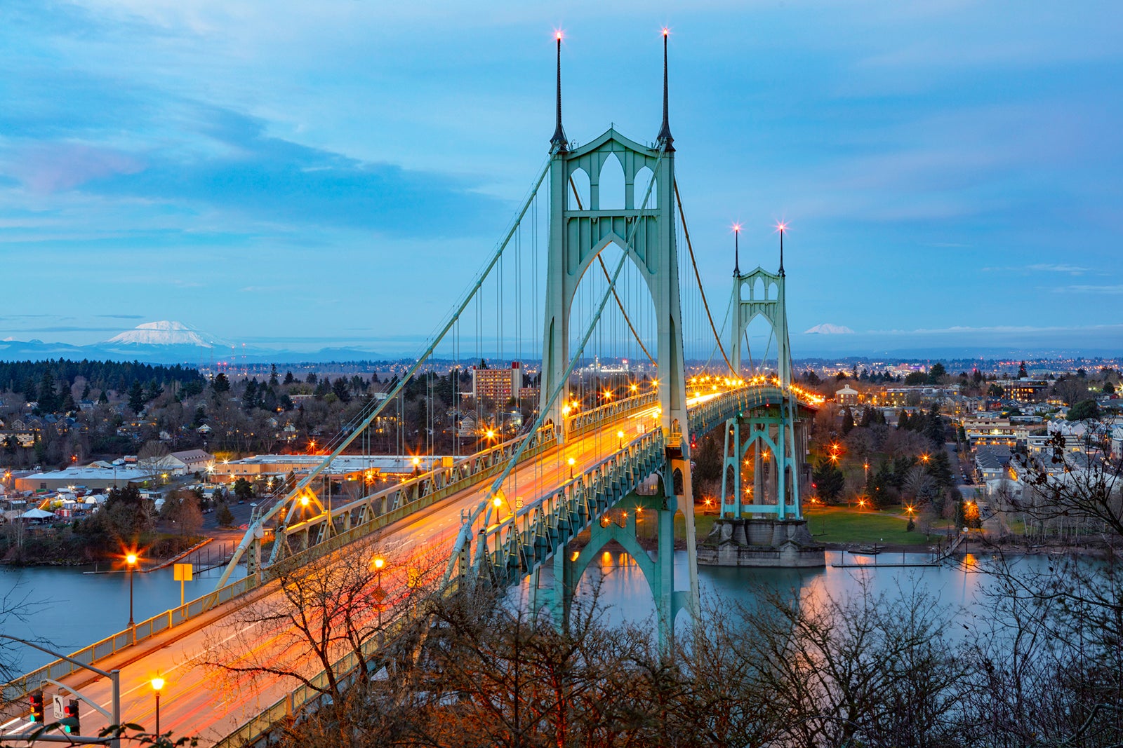 St Johns Bridge over the Willamette River in Portland, Oregon with Mt St Helens and Mt Adams in the distance. 