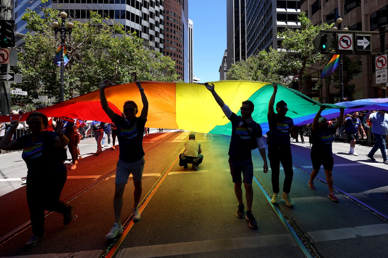 celebrators raising giant pride flag on SF street