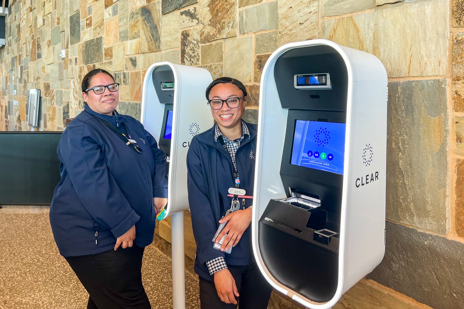 Two clear employees at two clear kiosks
