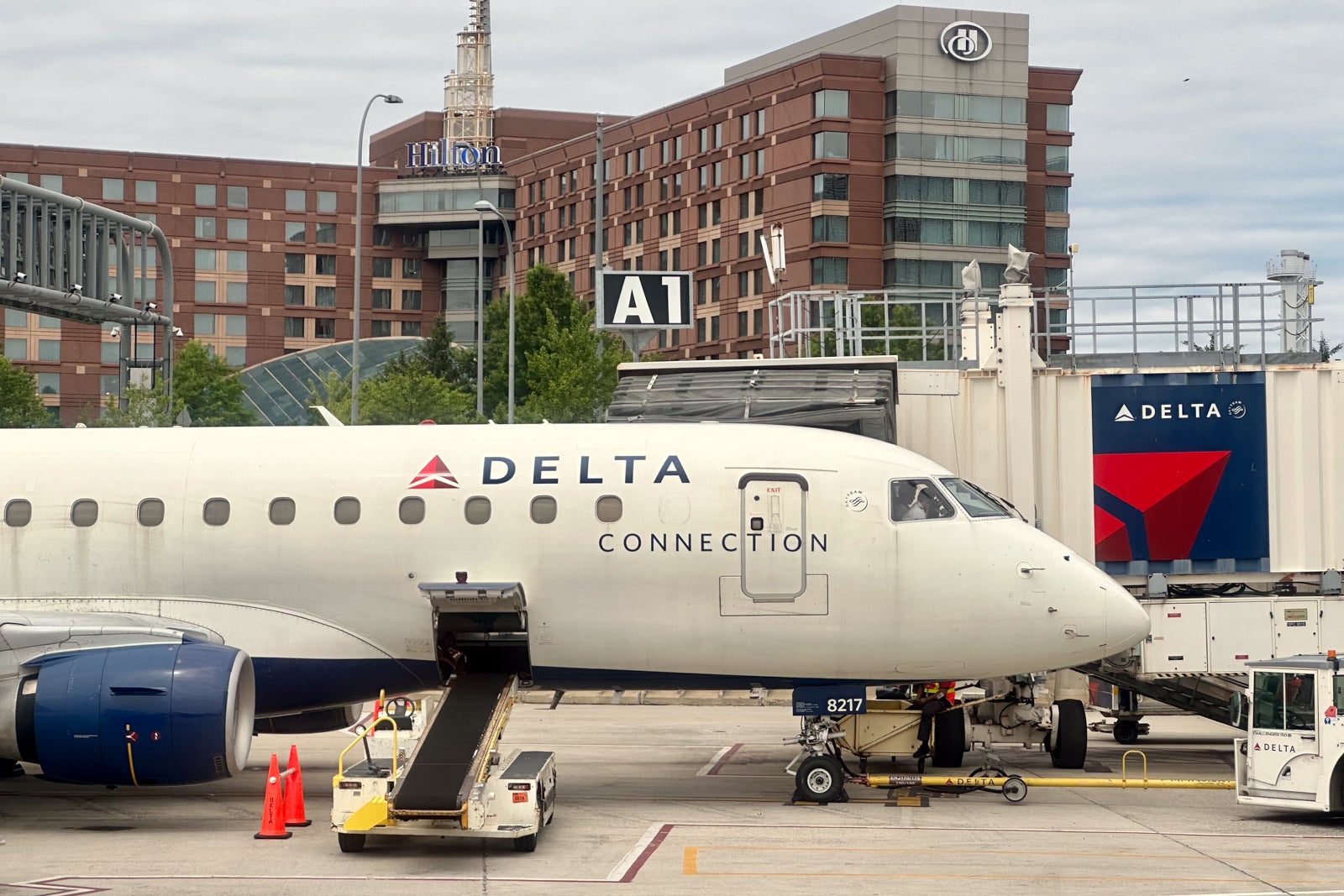 Delta plane at gate with hotel behind