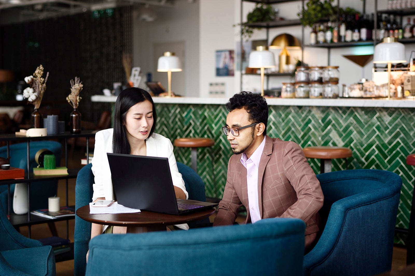 Two people looking at a laptop together