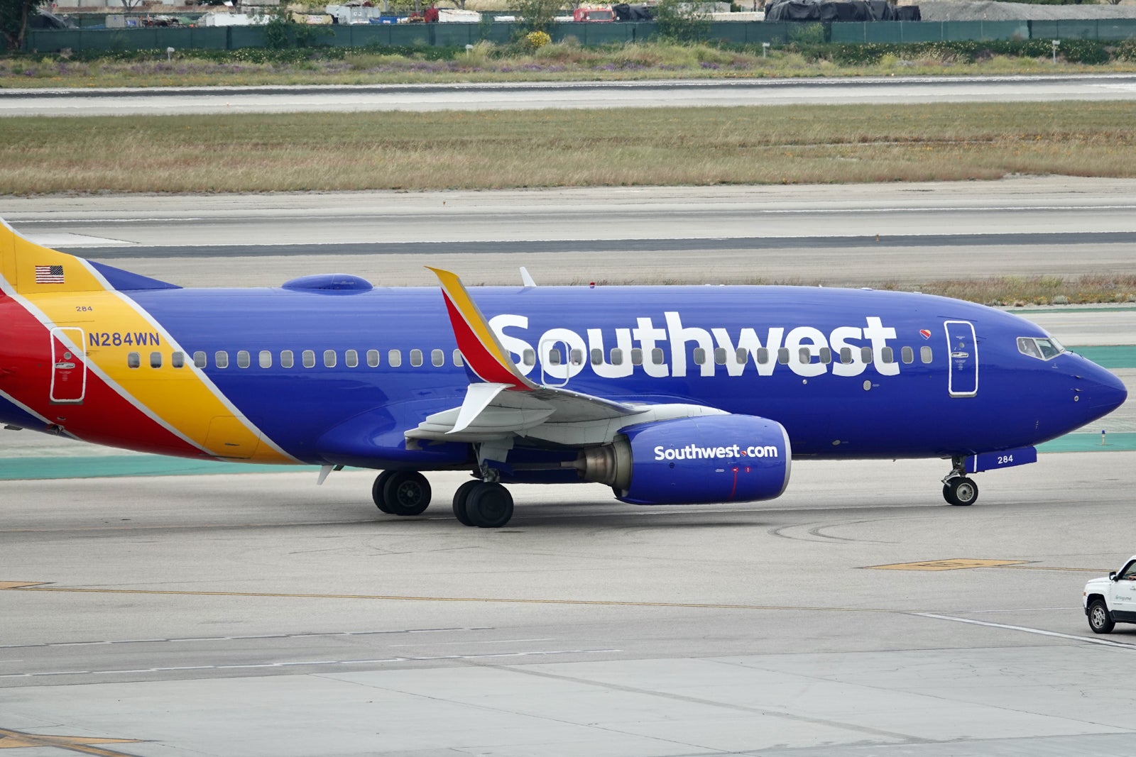 a blue Southwest plane taxies at an airport