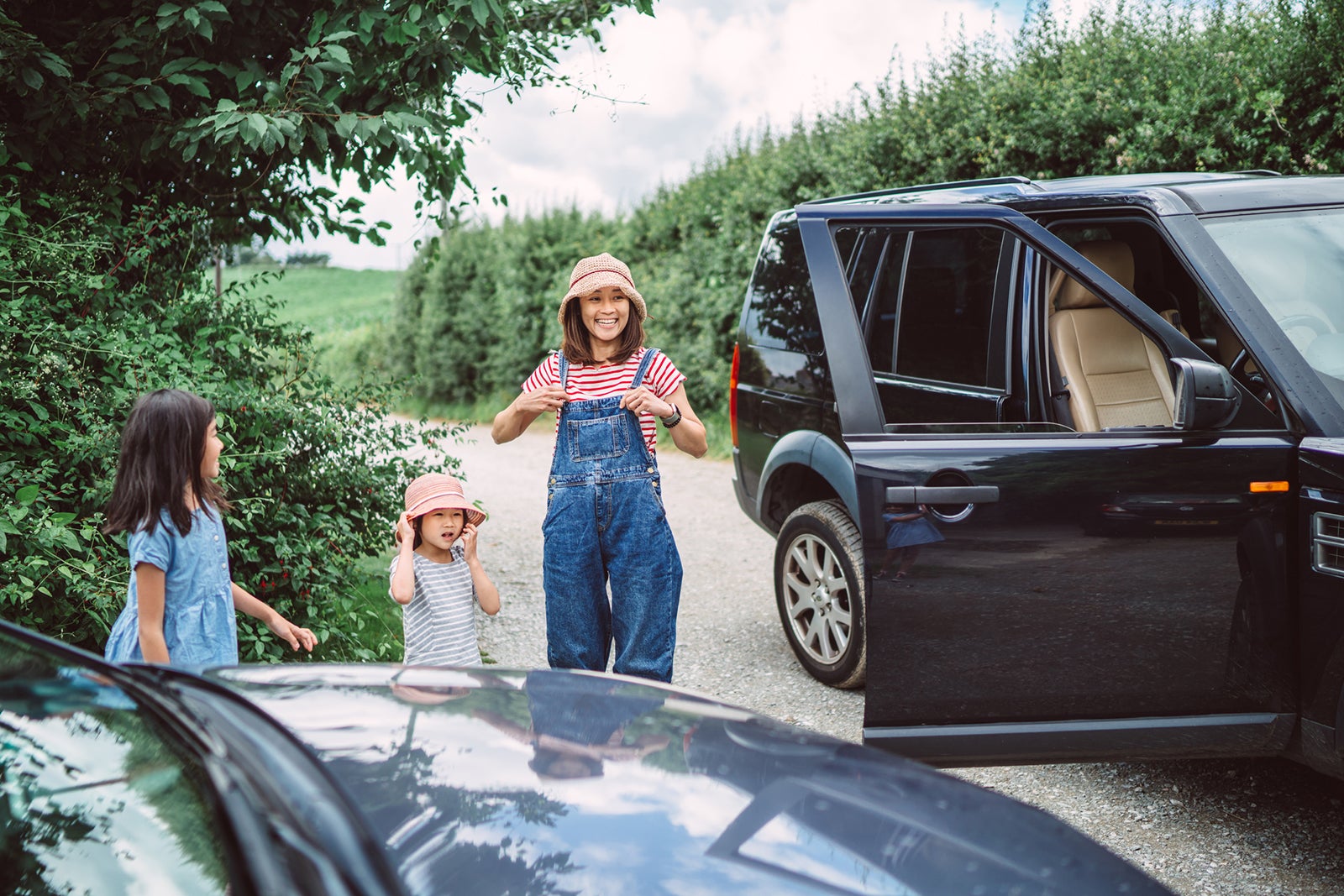 Young beautiful family meeting up with friends for road trip