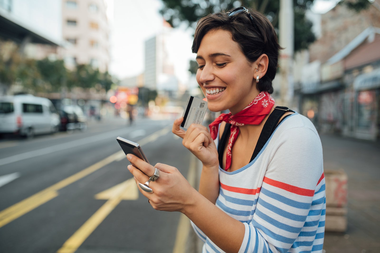 Woman using her card and phone