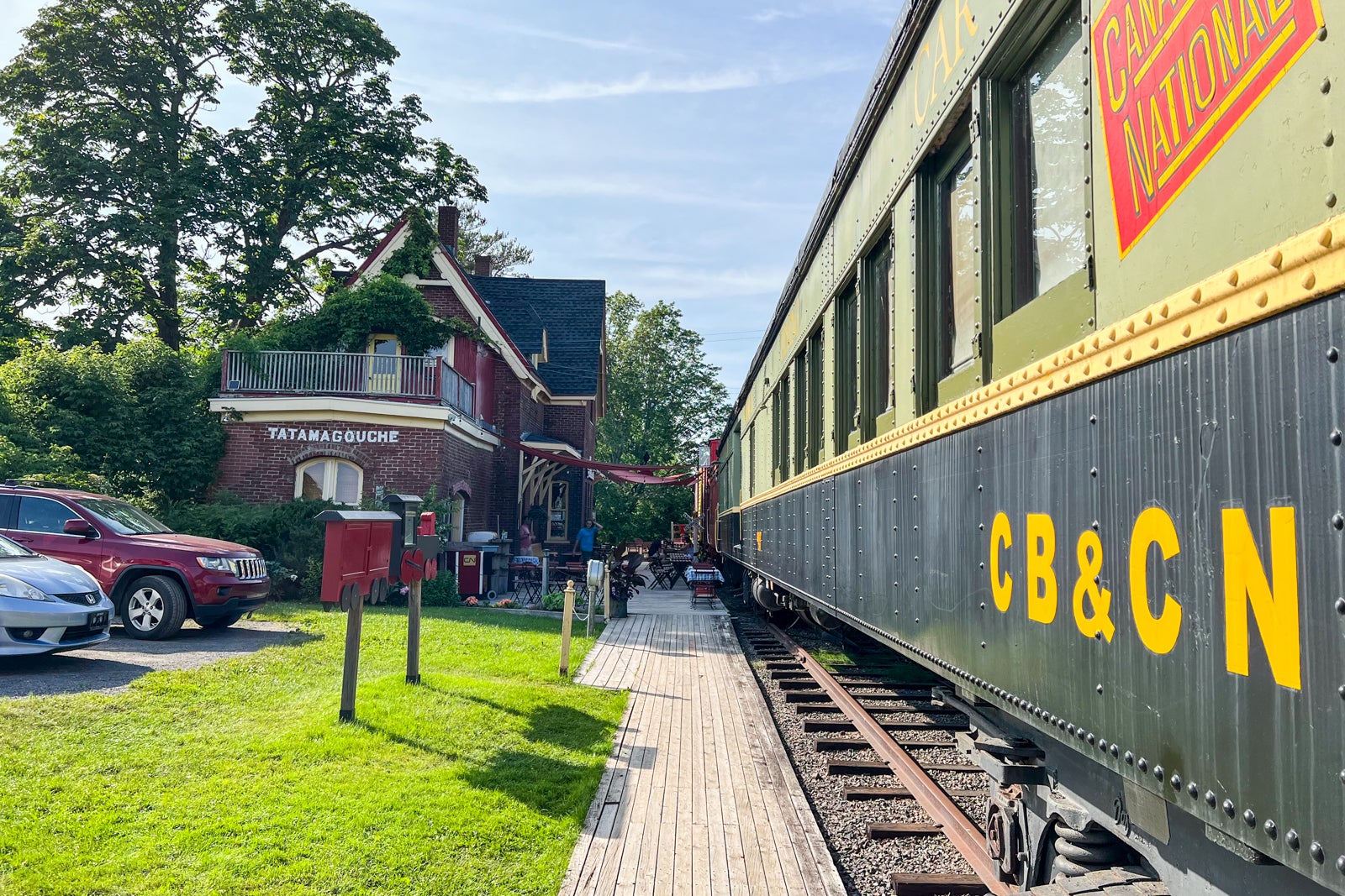 The main building and outside of the dining car at the Train Station Inn in Tatamagouche, Nova Scotia