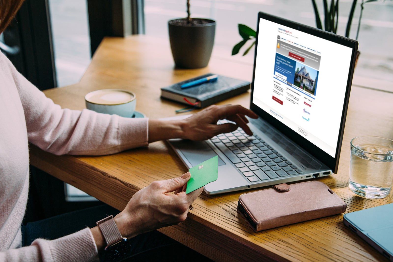 Woman at cafe shopping on laptop