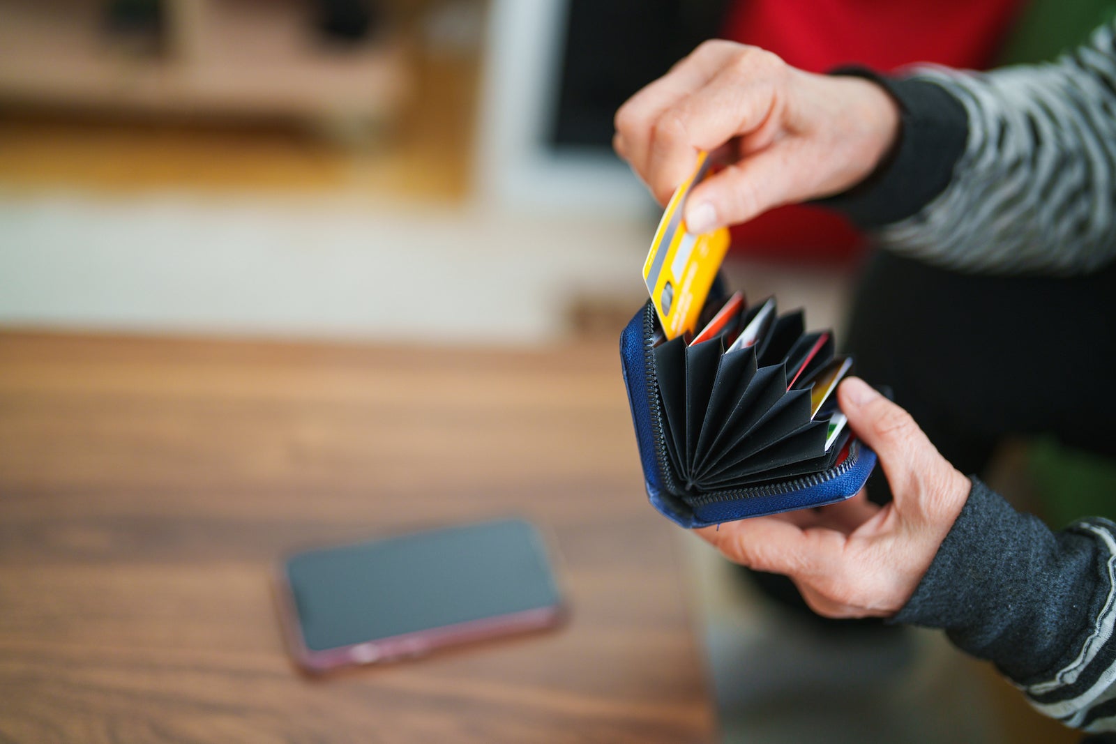 A person taking out her credit card from wallet