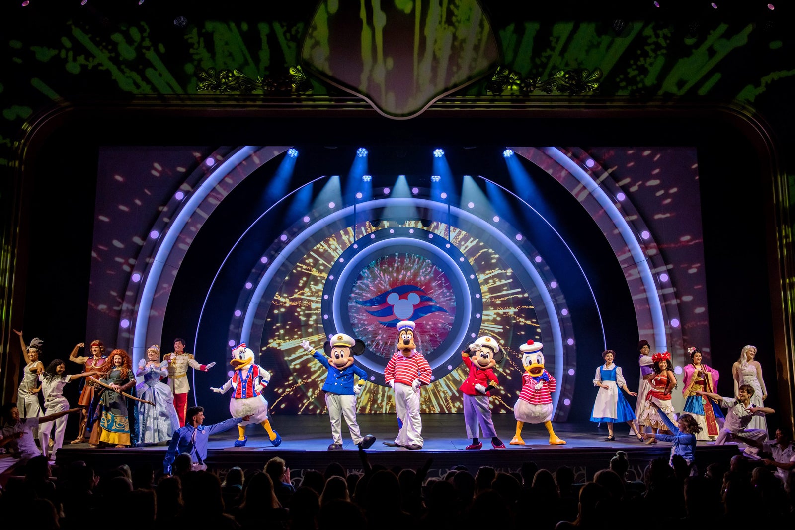 Disney characters and prince and princesses perform onstage.