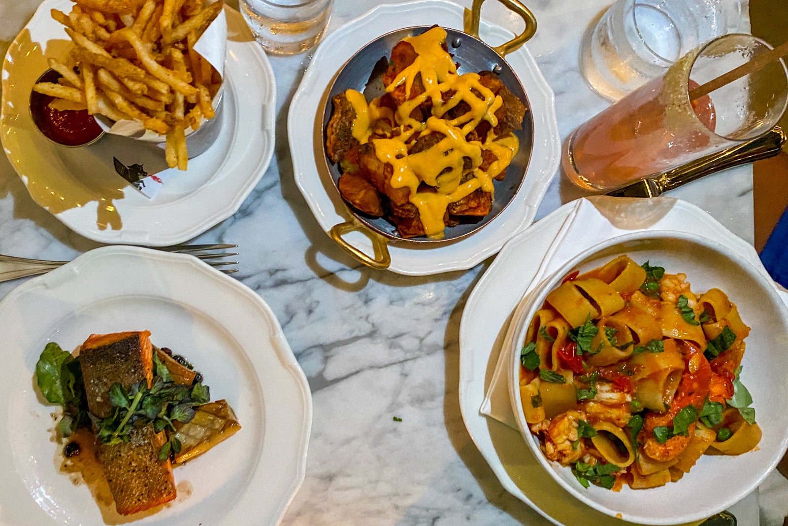 A meal featuring fish, french fries and pasta