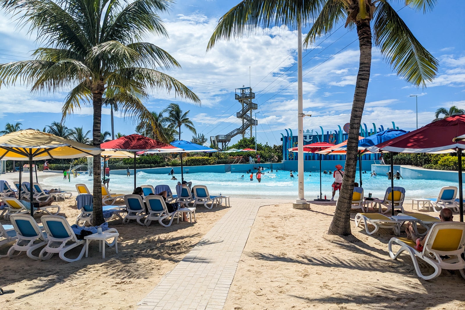 Beach with palm trees in front of wave pool