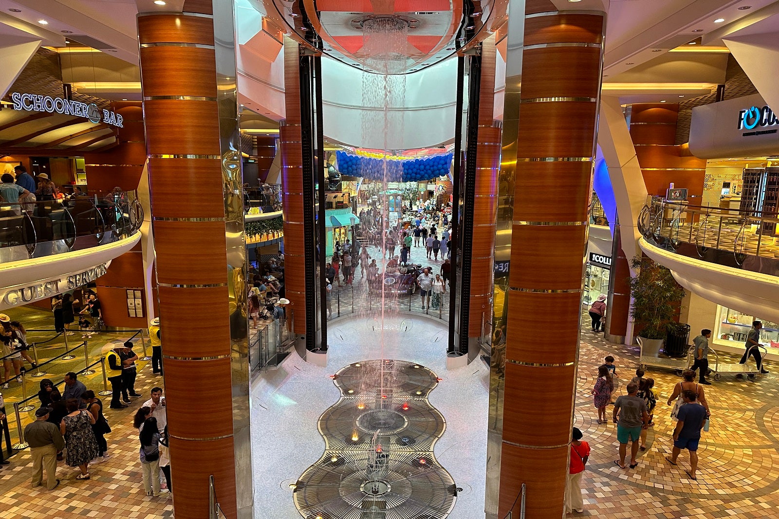 A three-deck-high fountain in the indoor promenade on a cruise ship