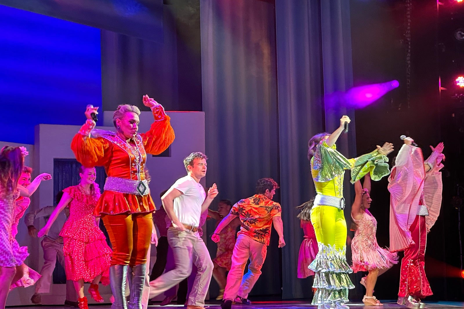 Entertainment staff on a cruise ship perform a scene from musical "Mamma Mia!"