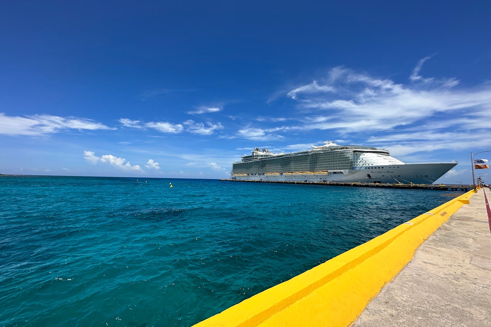 A cruise ship pier with a ship docked far away