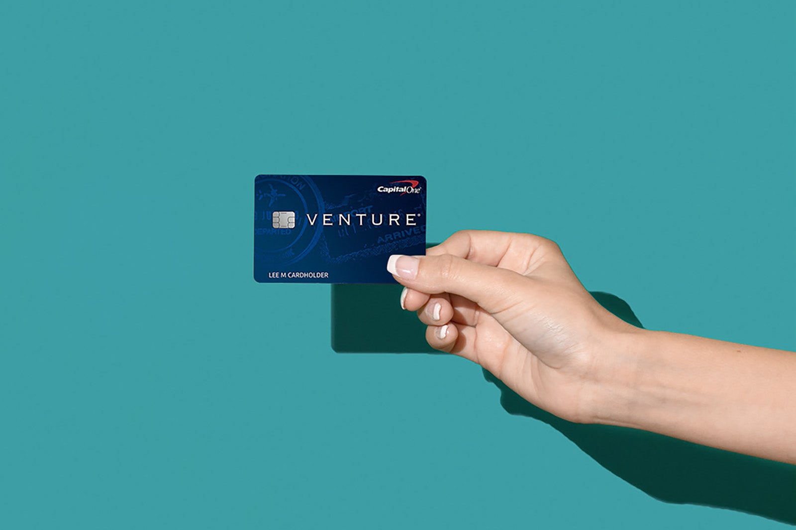 hand holding a capital one venture credit card