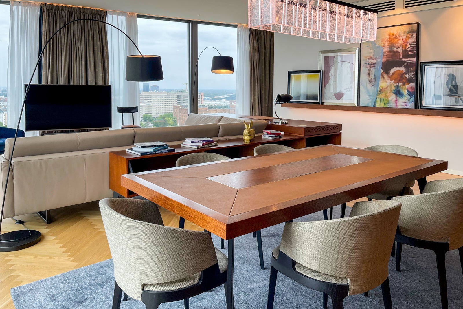 The dining table and living room at the Andaz Vienna Executive Suite