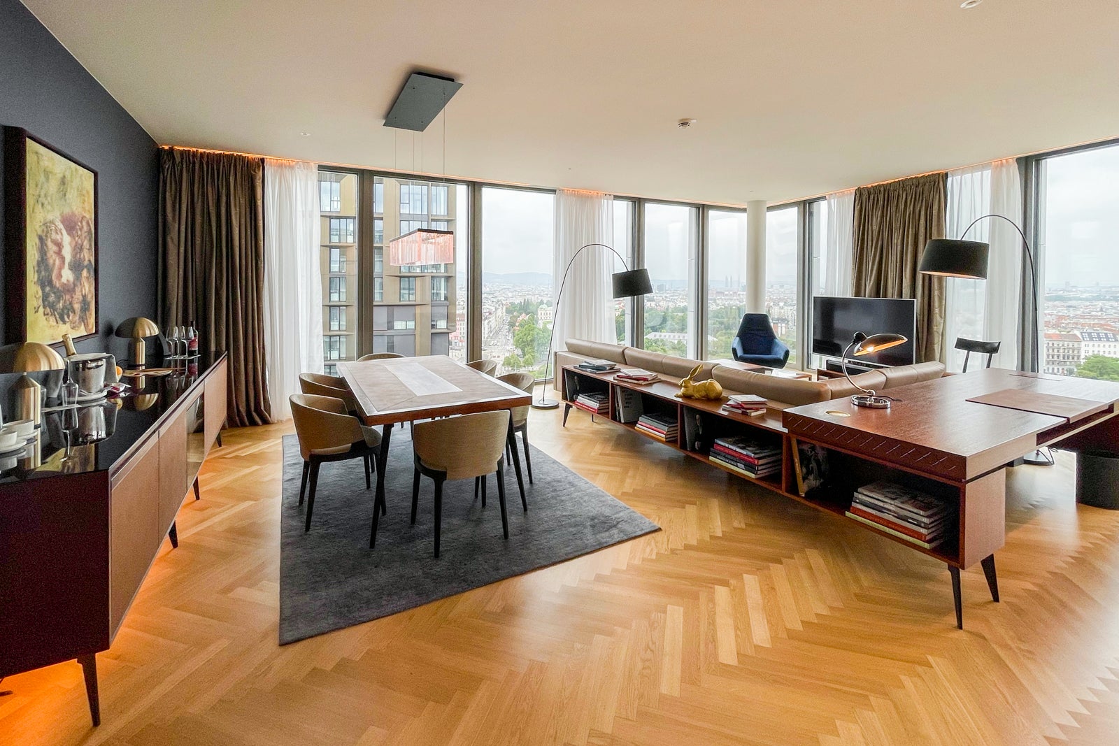 6-person dining table and living room at the Andaz Vienna Executive Suite