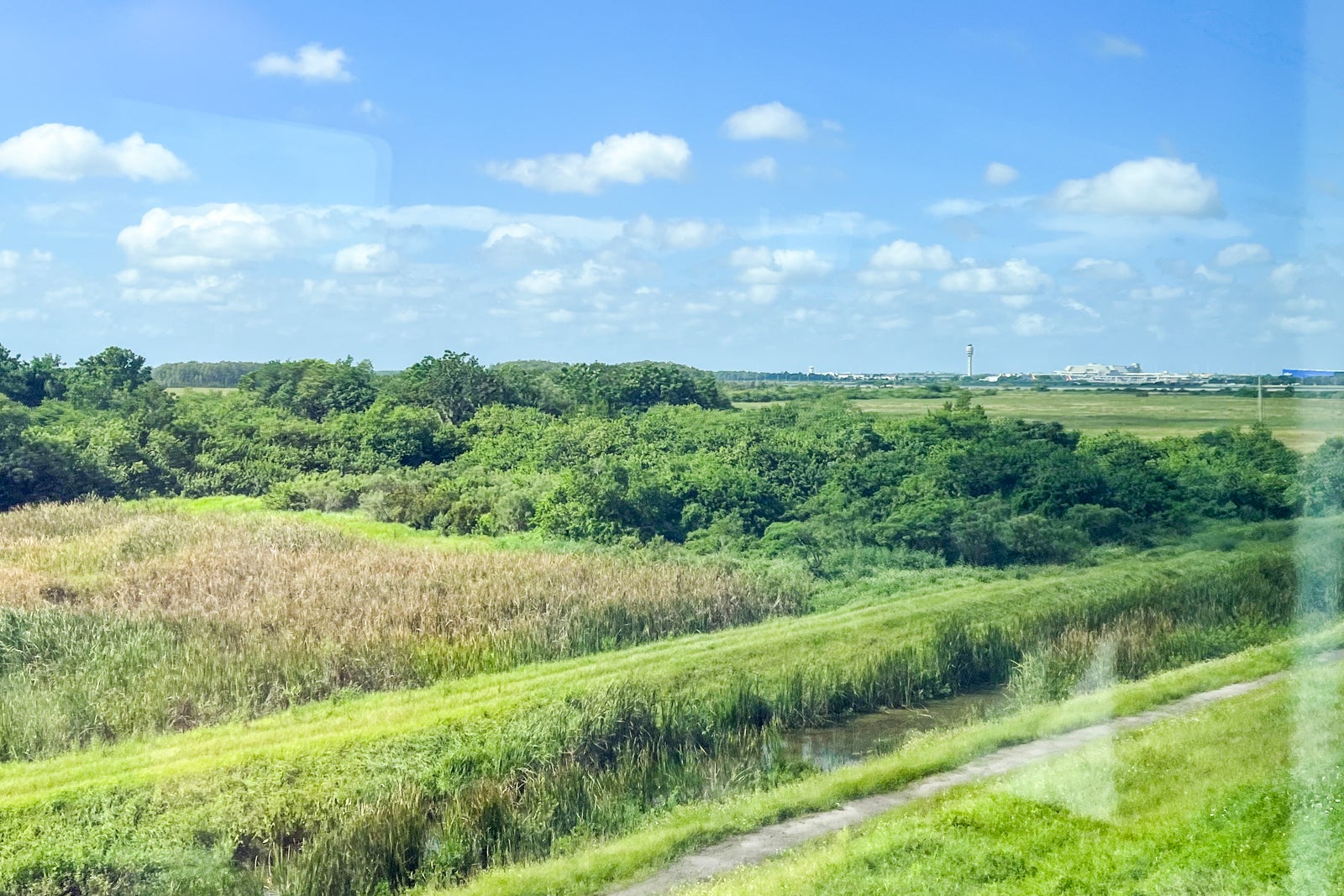 The Orlando Airport control tower in the distance, viewed from the inaugural Brightline train from Miami