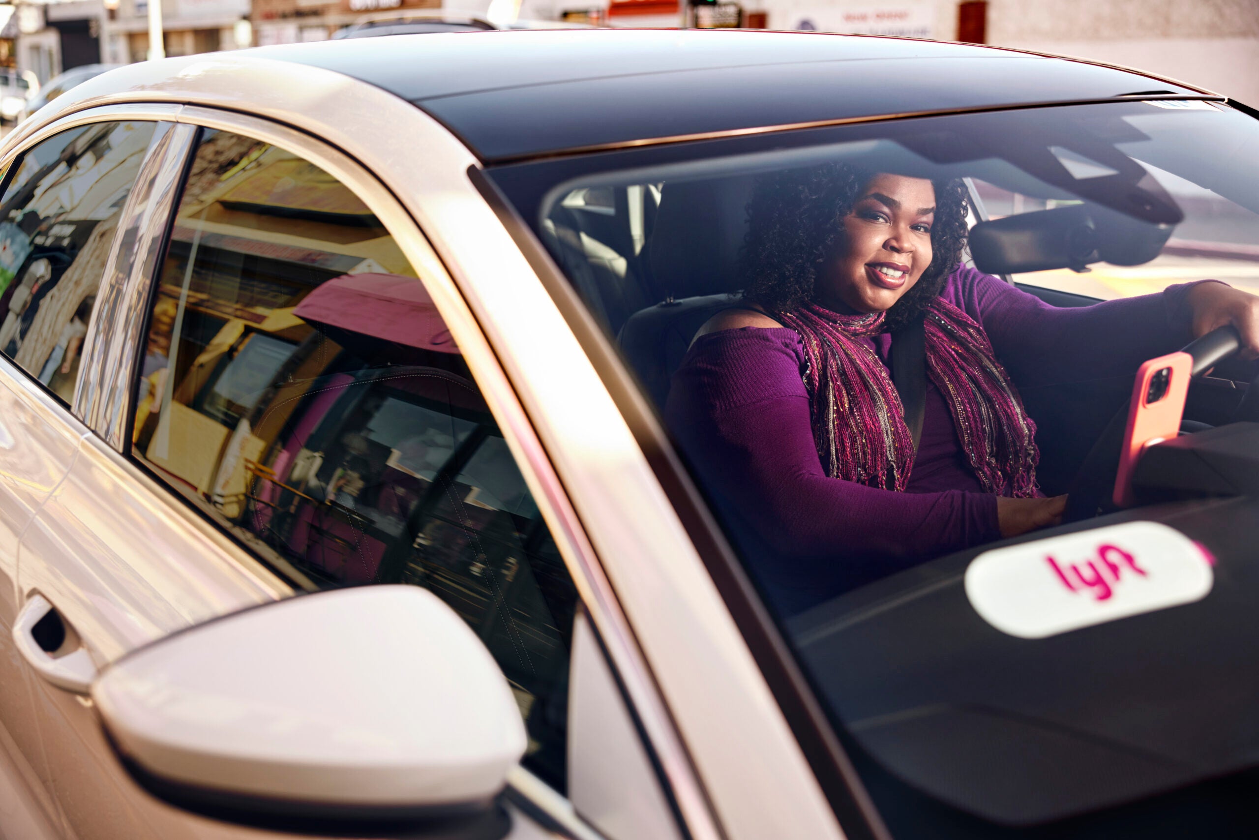 A woman lyft driver in a car