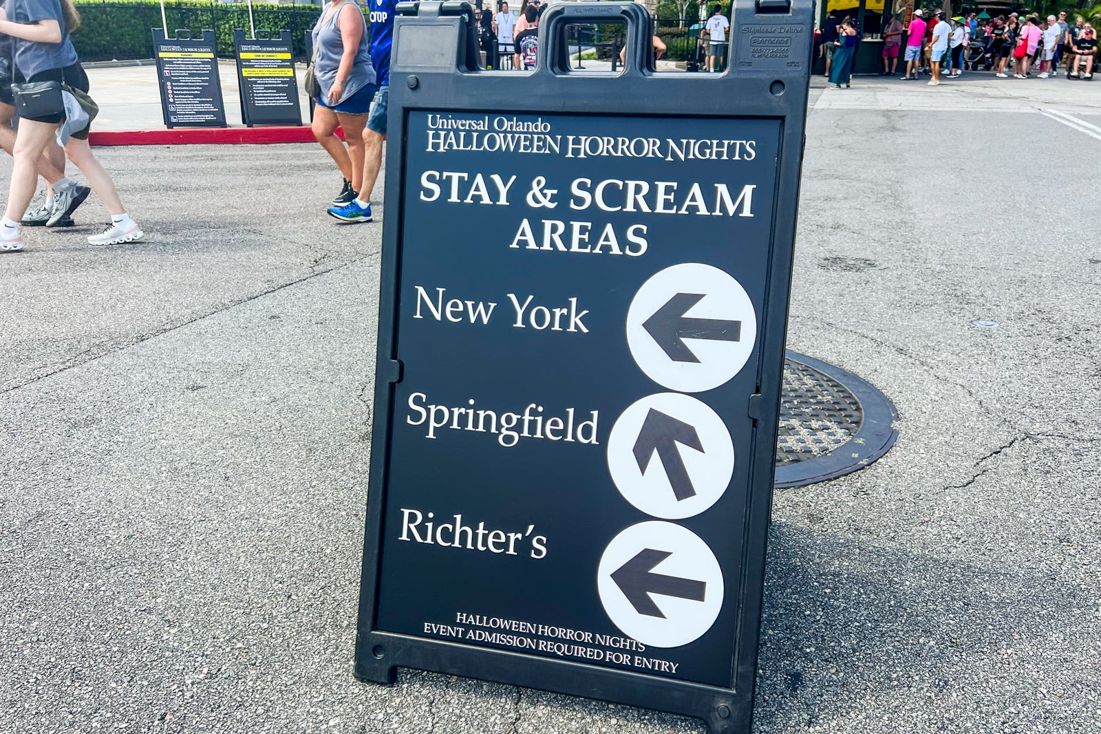 Halloween Horror Nights sign directing people to different areas of park