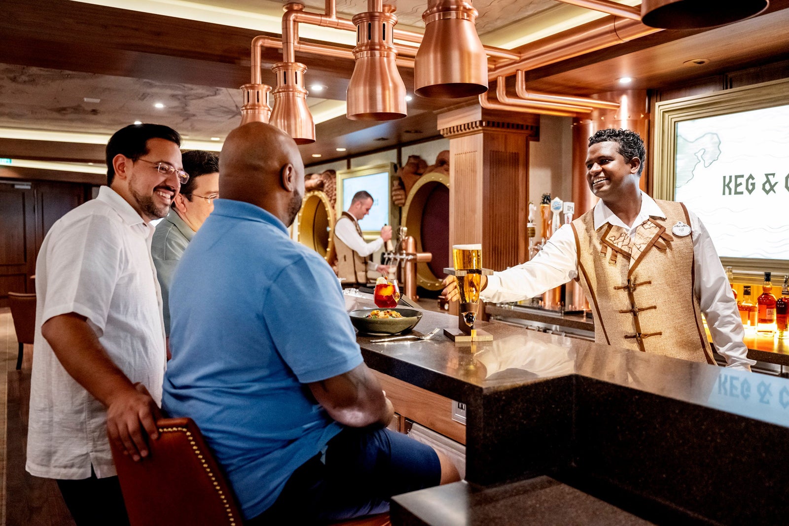 passengers enjoying drink at Keg & Compass on Disney Wish