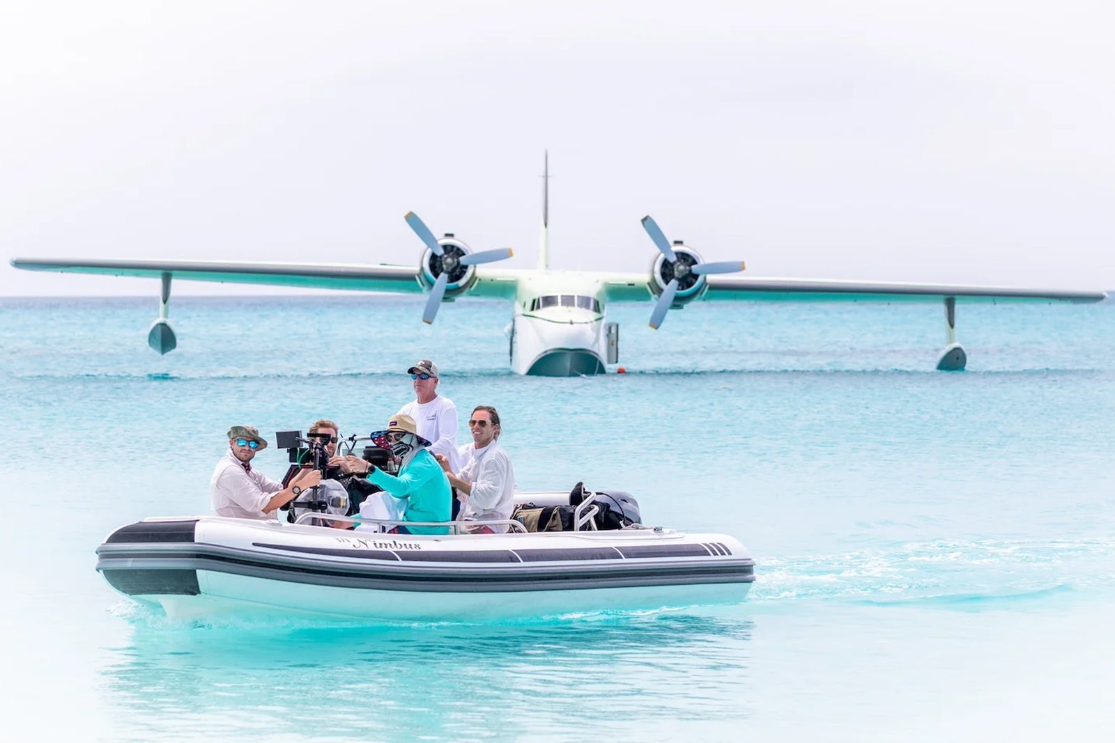 boat in water with plane in background