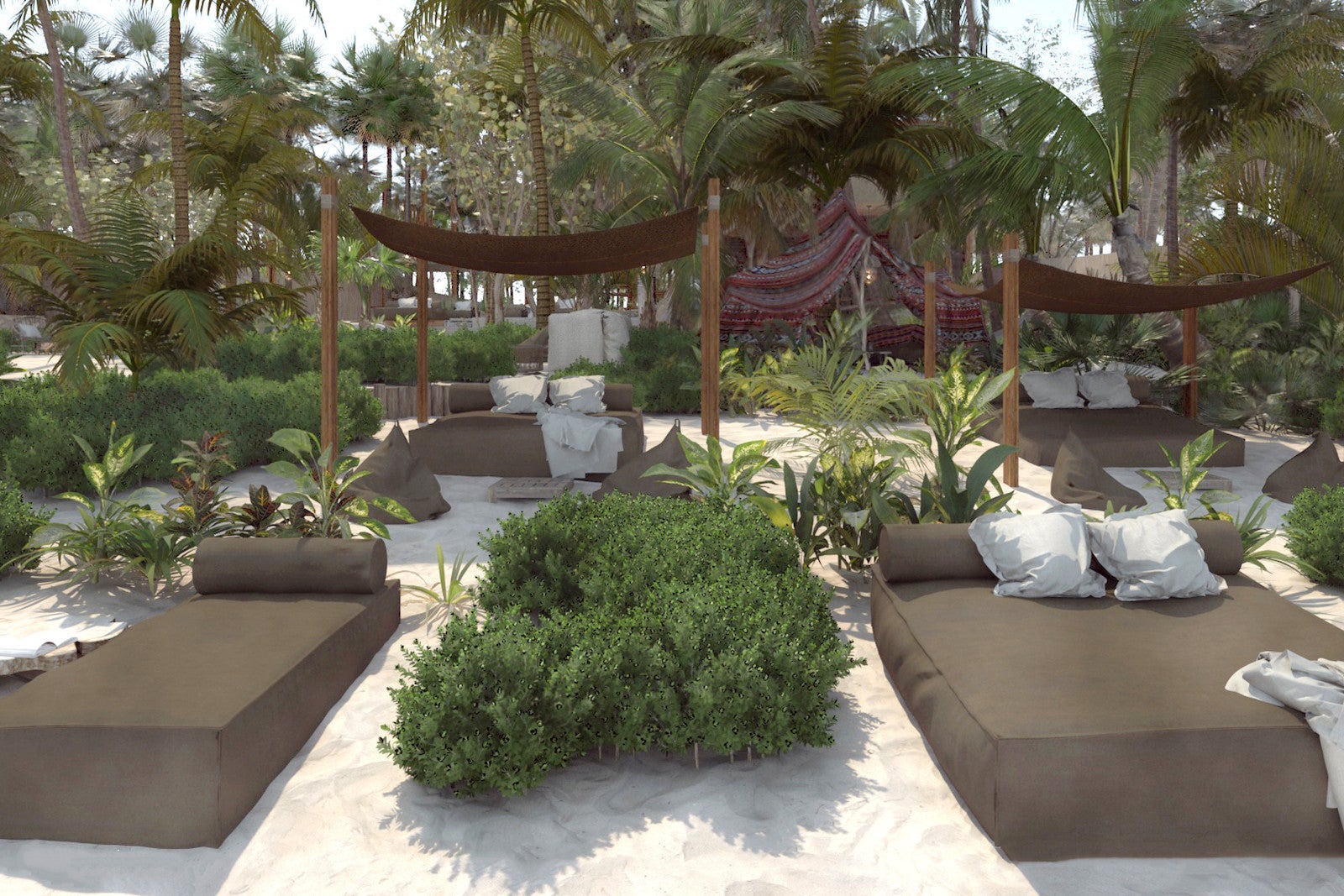 large daybeds with pillows on the sand surrounded by greenery