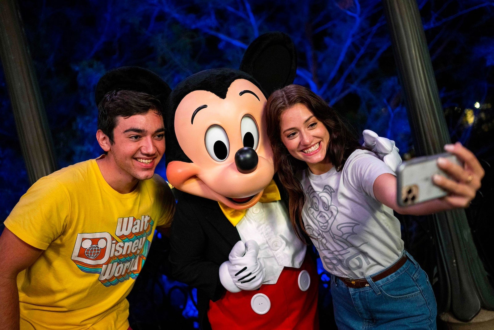 Guests take a photo with Mickey at Disney World