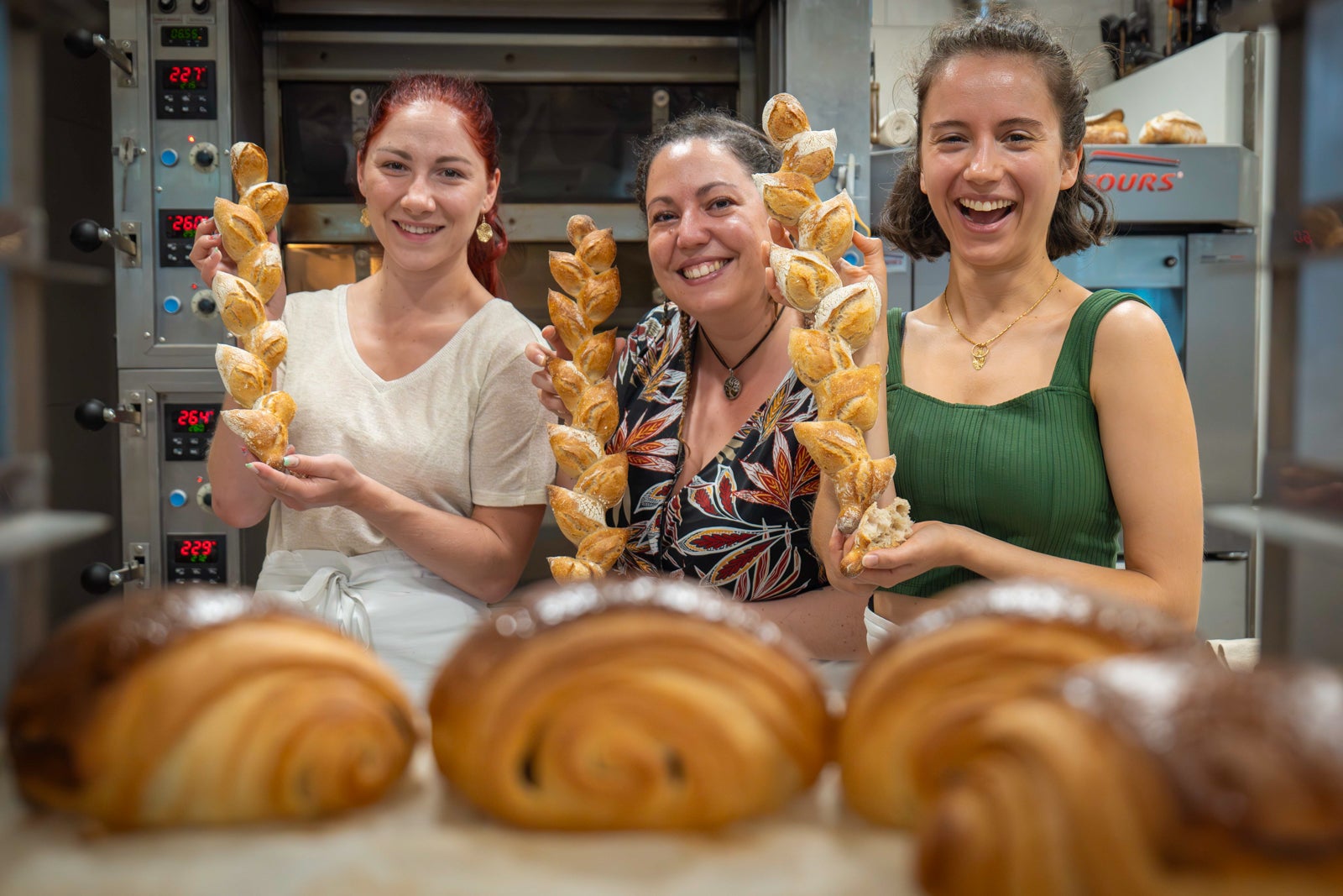 women holding up baked goods