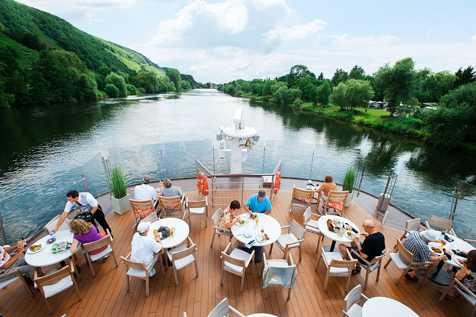 River cruise passengers dine on boat's top deck