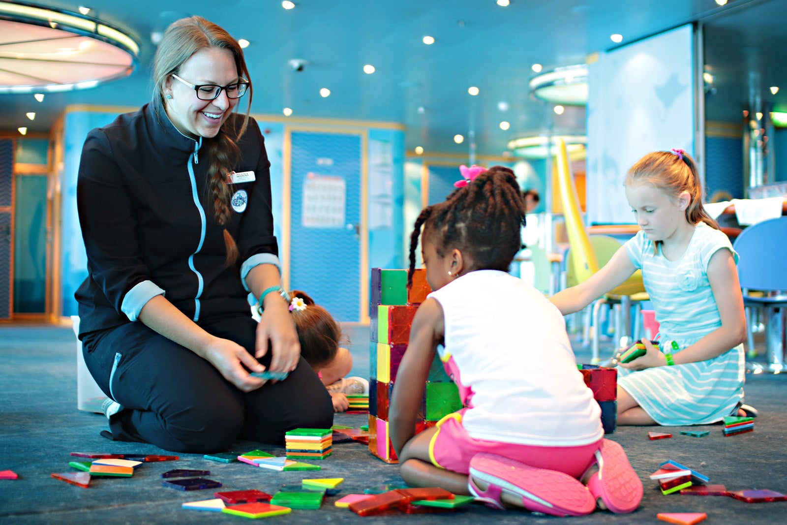 Counselor and kids playing in cruise ship kids club