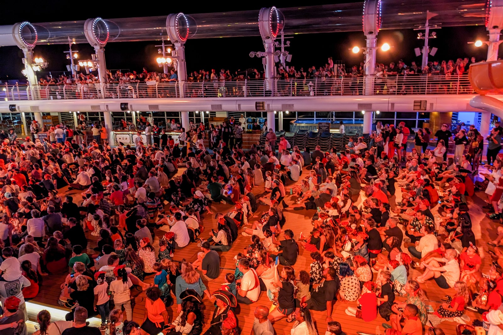 Crowds of people on a Disney cruise pool deck