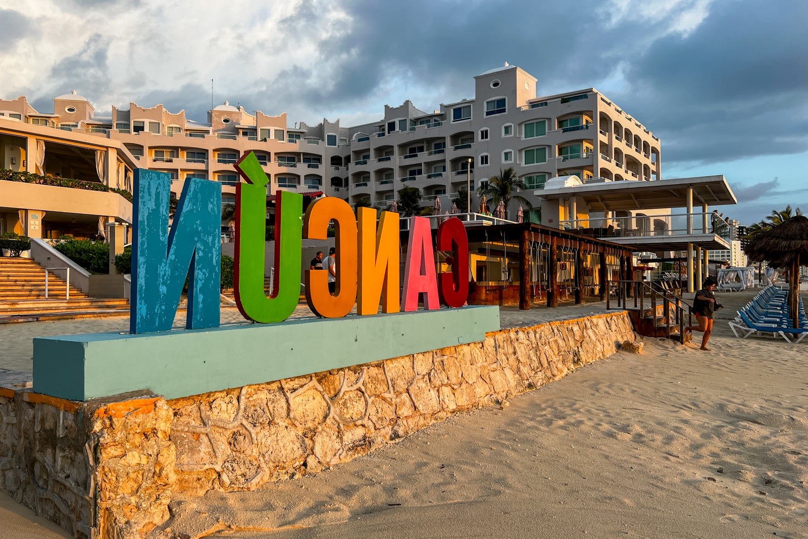 rainbow Cancun sign in front of beach hotel