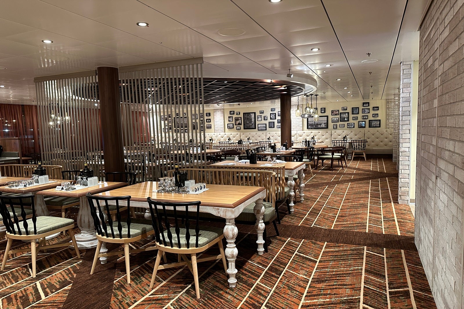 A cruise ship dining room with wooden tables and chairs