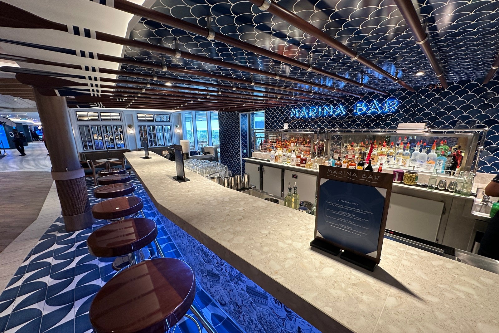 A nautically themed bar with mermaid fish scale tiles on a cruise ship