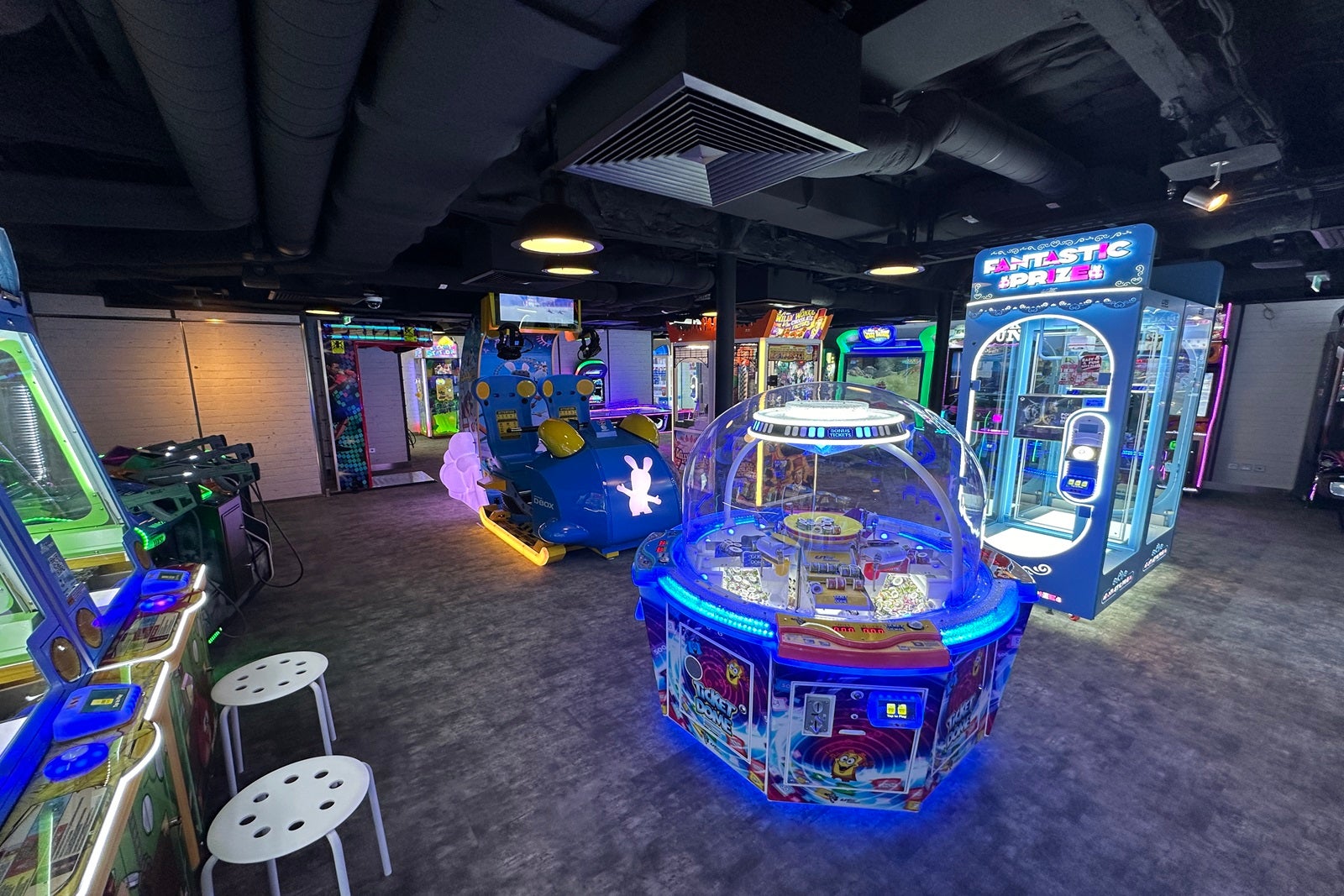 An arcade outfitted with games lit by neon lights