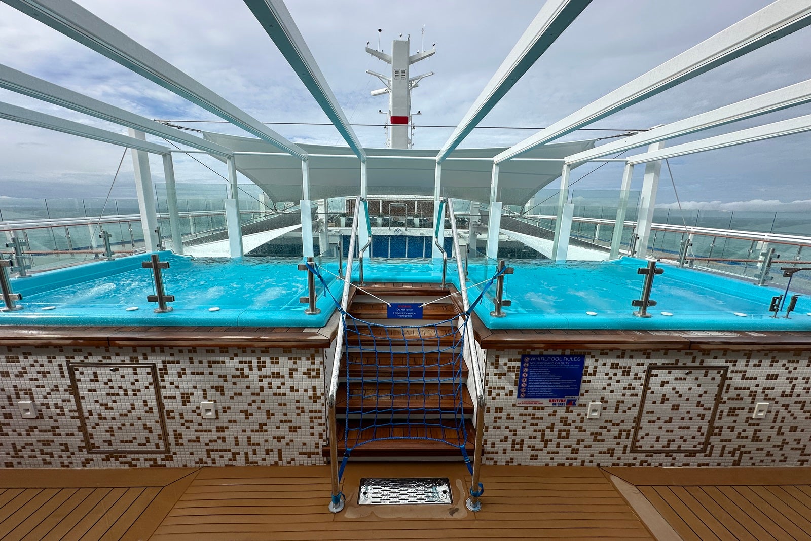 Steps leading to a set of twin hot tubs on a cruise ship