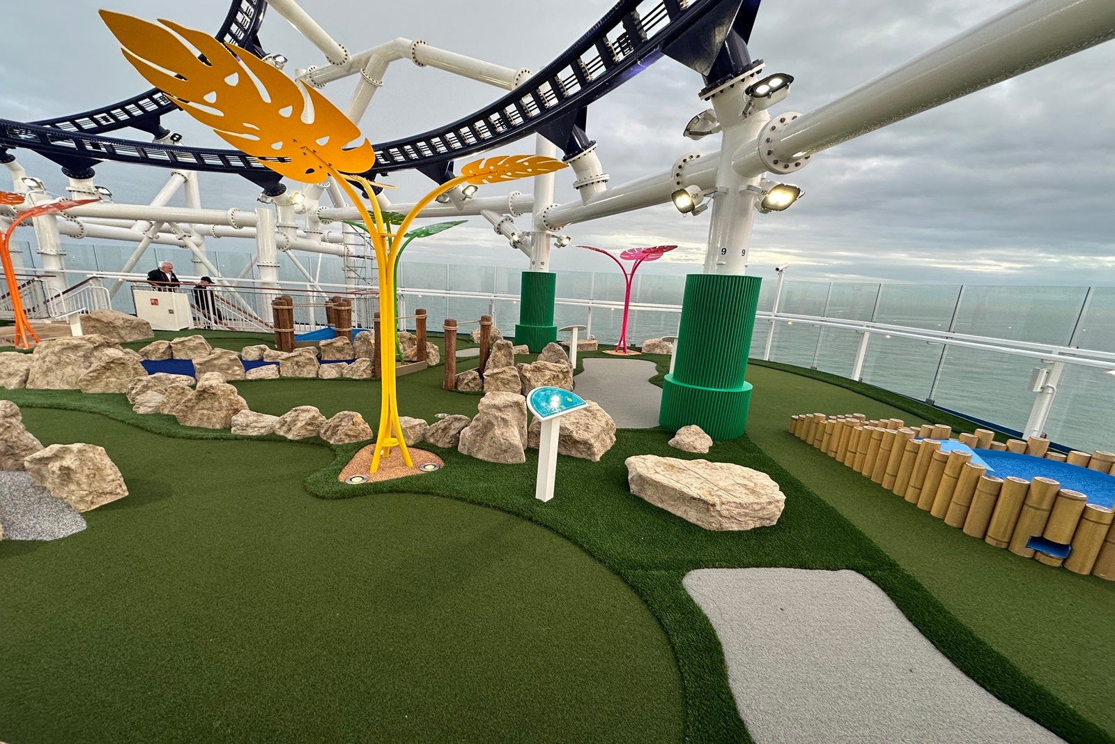 Part of a cruise ship miniature golf course with a portion of roller coaster track overhead