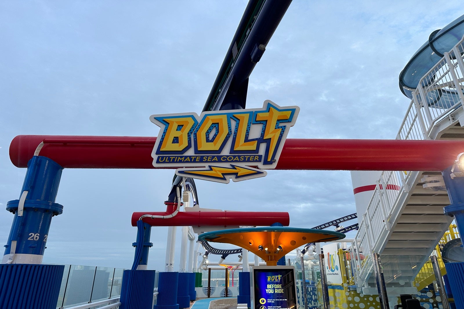 A yellow and blue sign reading "Bolt" mounted on a red pole