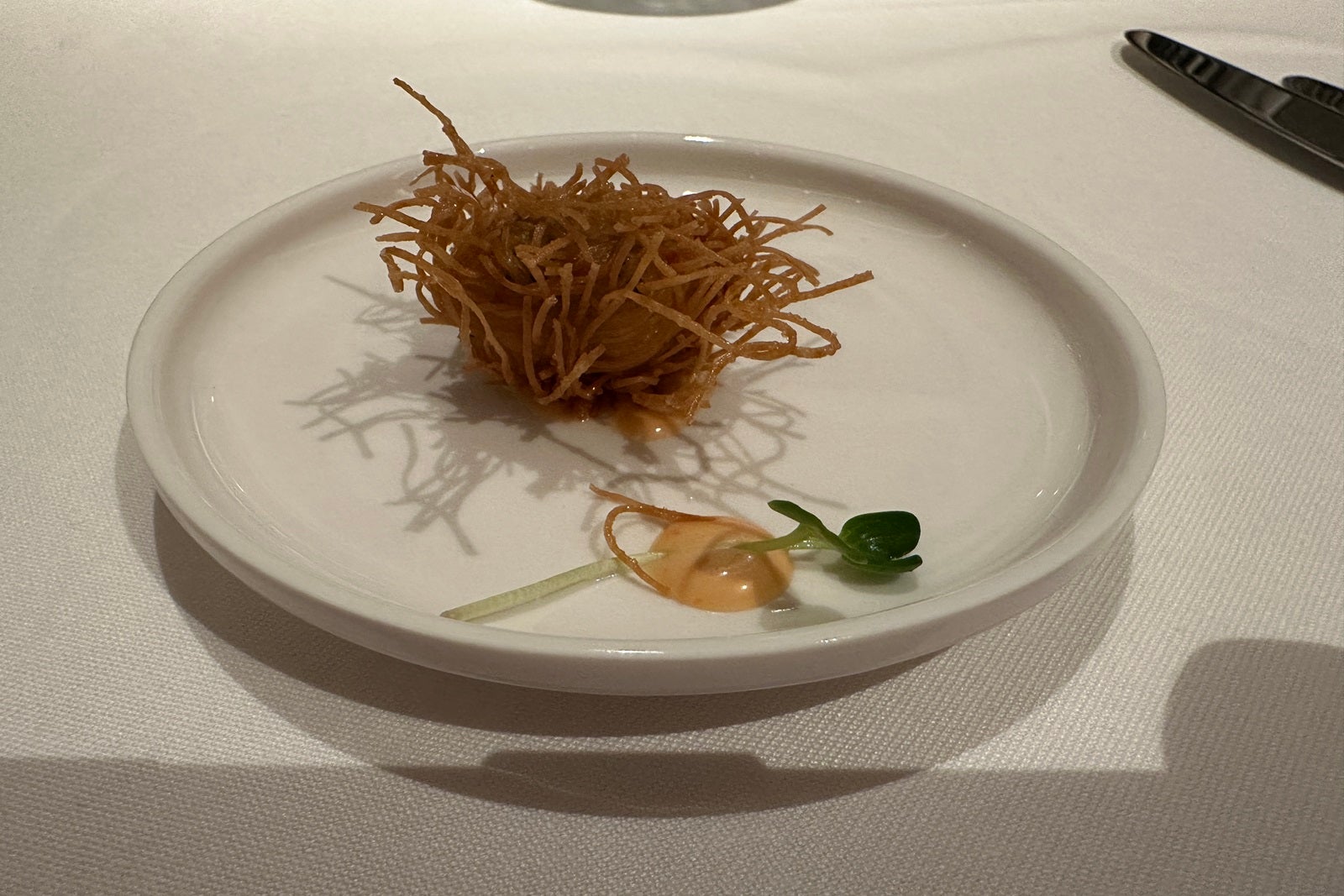 A spiny ball of fried shrimp on a white plate