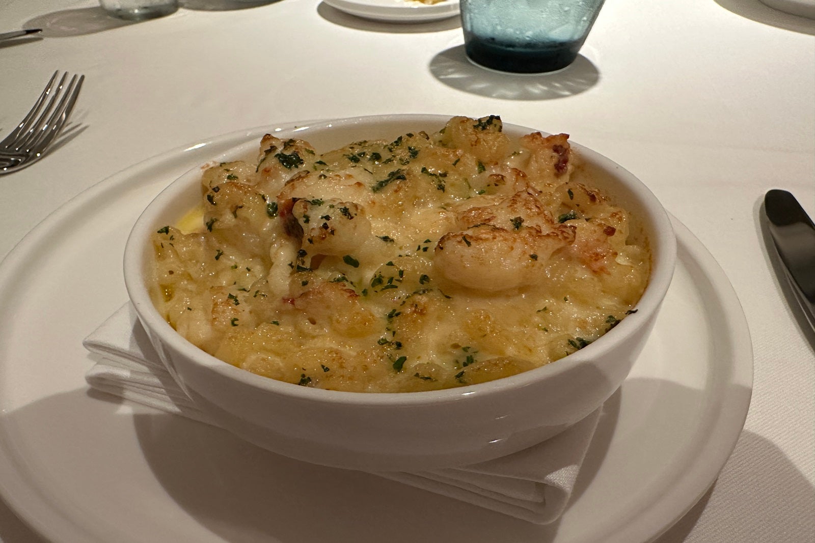 A white bowl filled with lobster macaroni and cheese