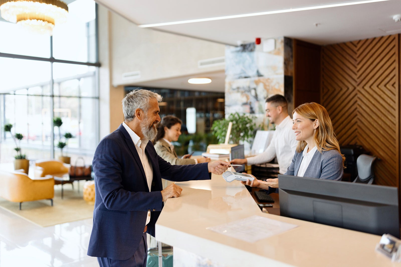 A man checking into a hotel