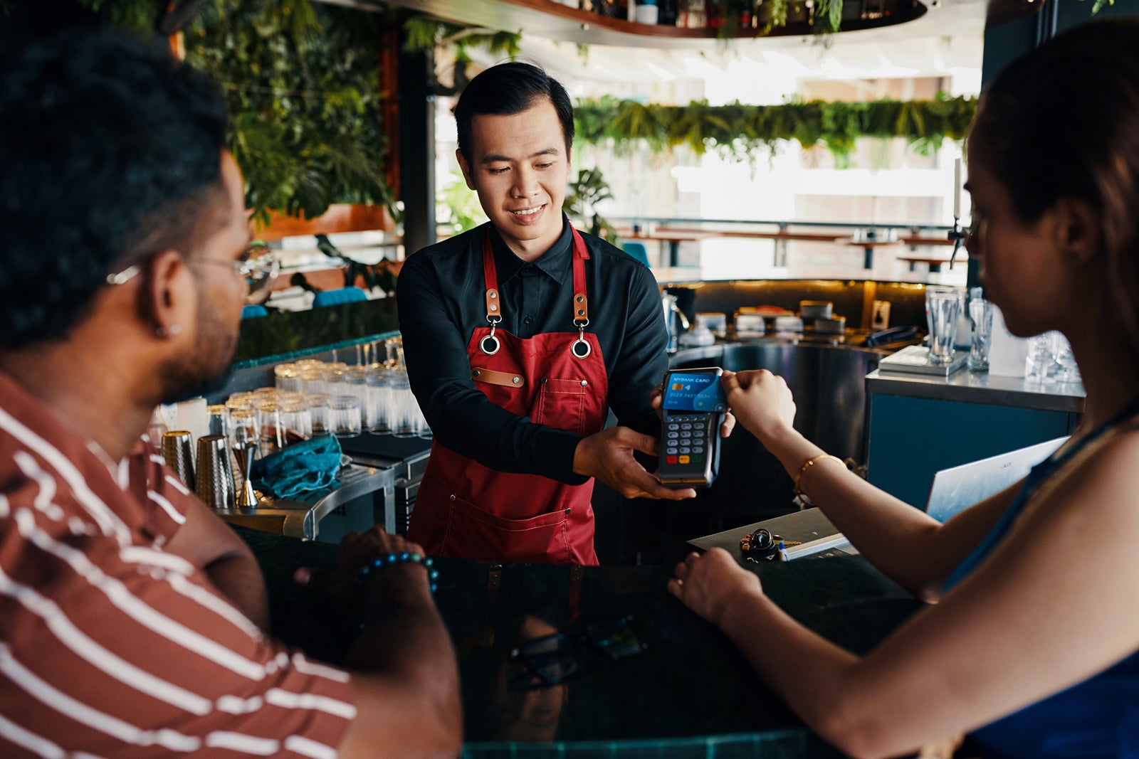 Woman Paying Bill in Bar