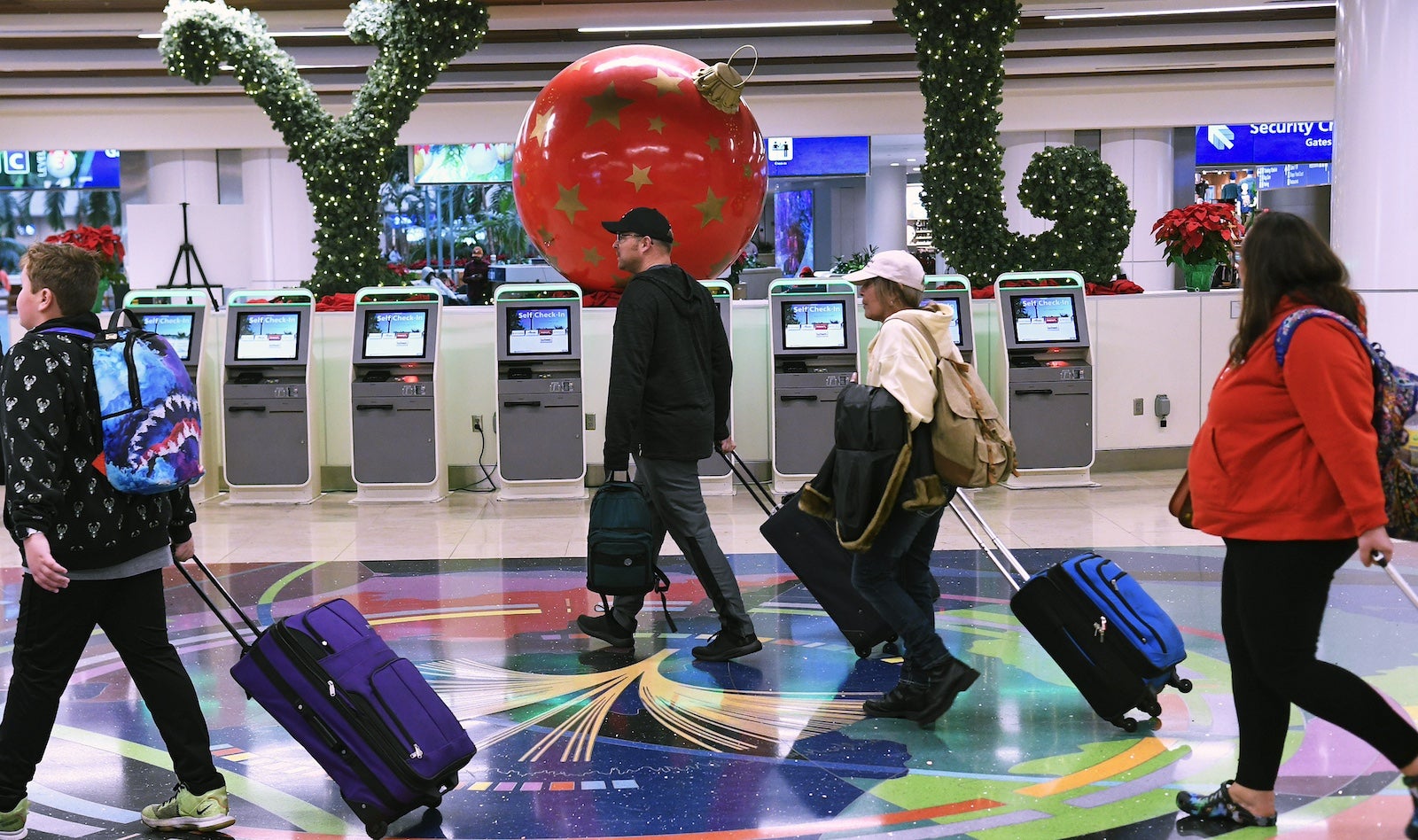 Passengers walking through Orlando airport during the holidays